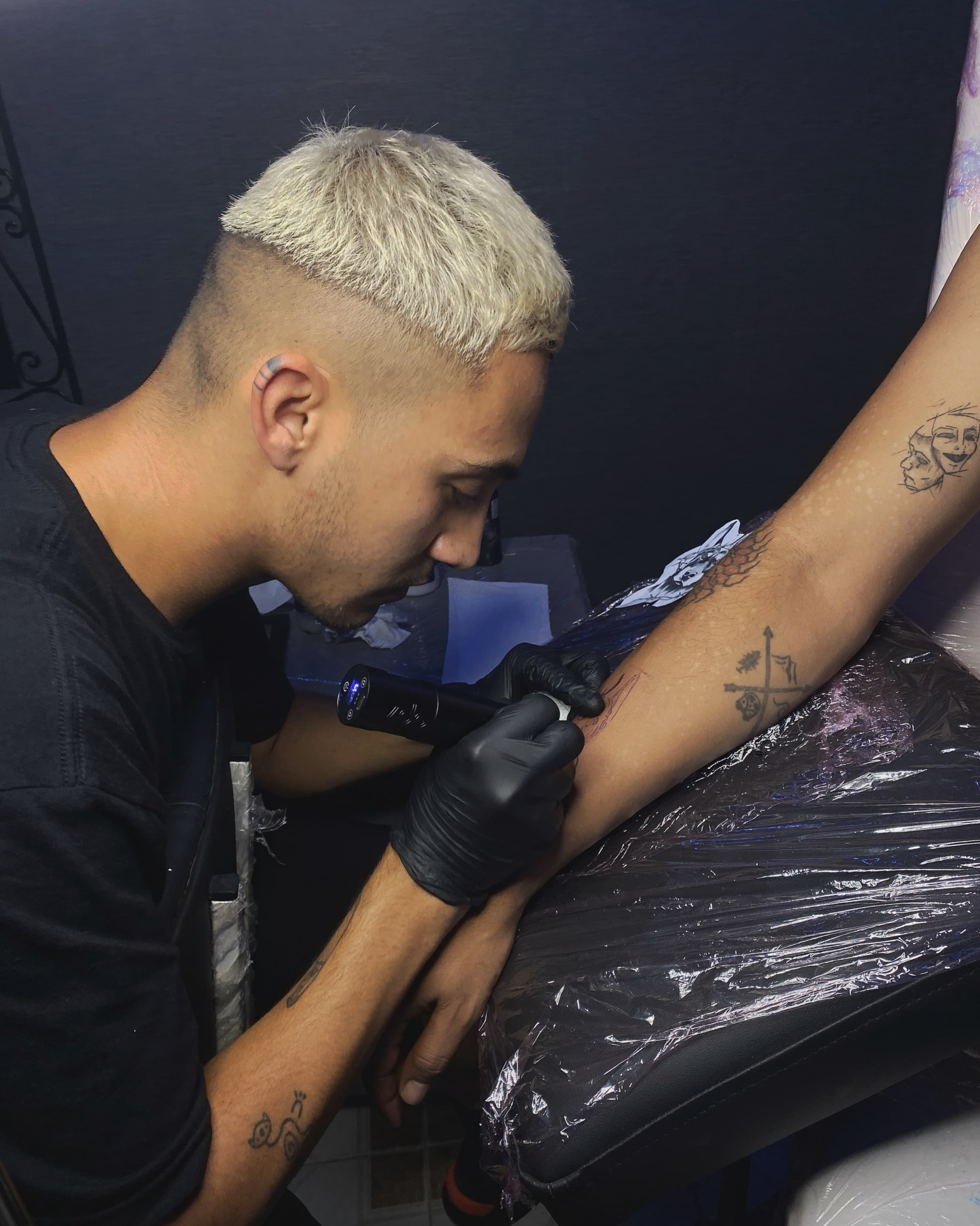 Tattoo artist working